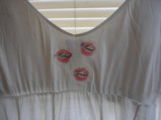 The back of the shirt includes the names of Kay's three children. Kim found the lips blotted on a piece of paper in one of Kay's books. A Duluth printed printed them on the shirt. Kay kissed everything with her big pink lips, says her sister.