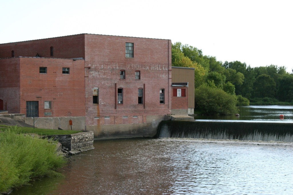 Faint Faribault Woolen Mill lettering remains on the old section of the mill complex.