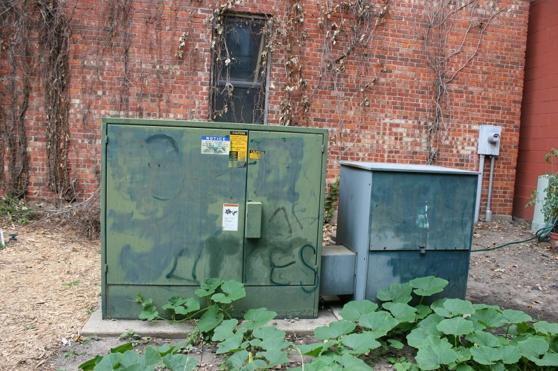 Plans call for latticework to eventually hide these utility boxes.