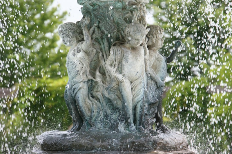 Water spills over the fountain cherubs.