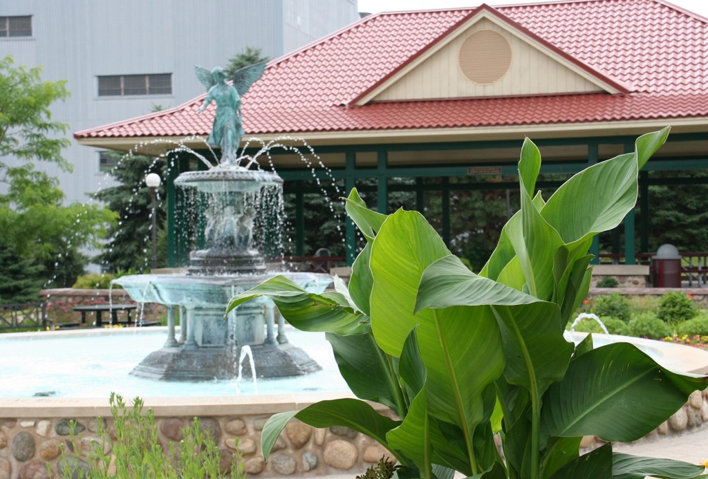 The Angel Fountain centers the park which features an abundance of plants and flowers.