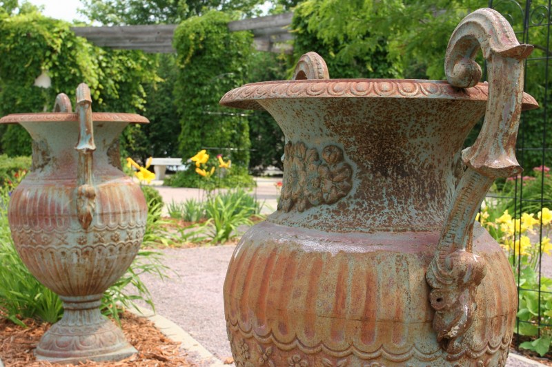 I love these rustic urns, which are so large and heavy it would take several people to move them.
