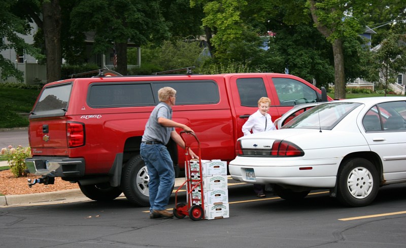 Volunteers are available to wheel peaches outside and load into vehicles.