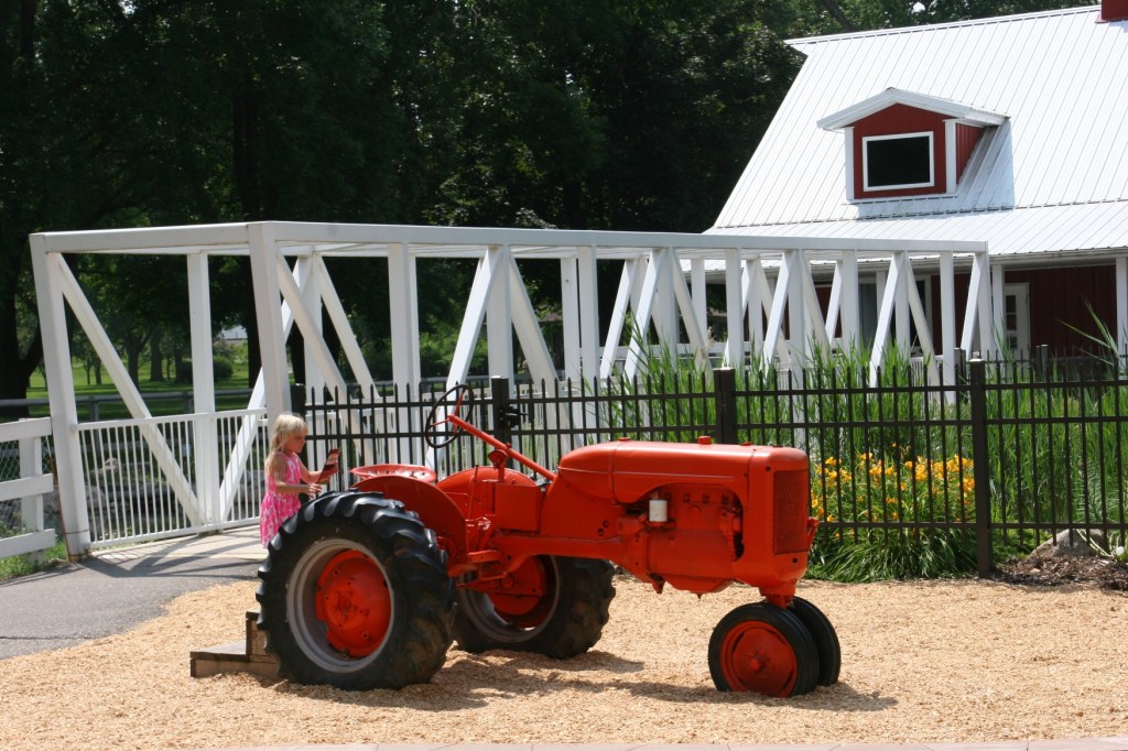 Kids love the tractors, this one located next to the bridge spanning the pond stocked with fish and dotted with water lilies.