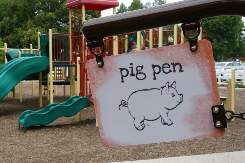 Love the signage at the farm-themed playground. There's also traditional playground equipment, background.