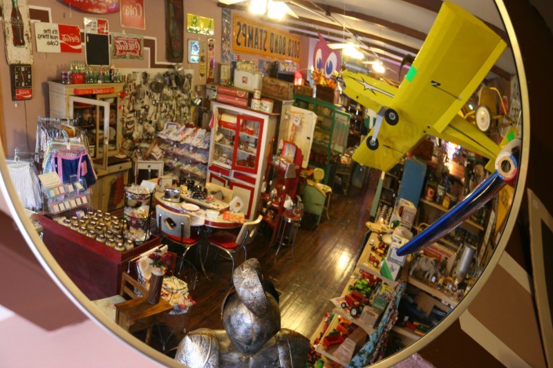 A security mirror reflects inventory in a section of the shop.