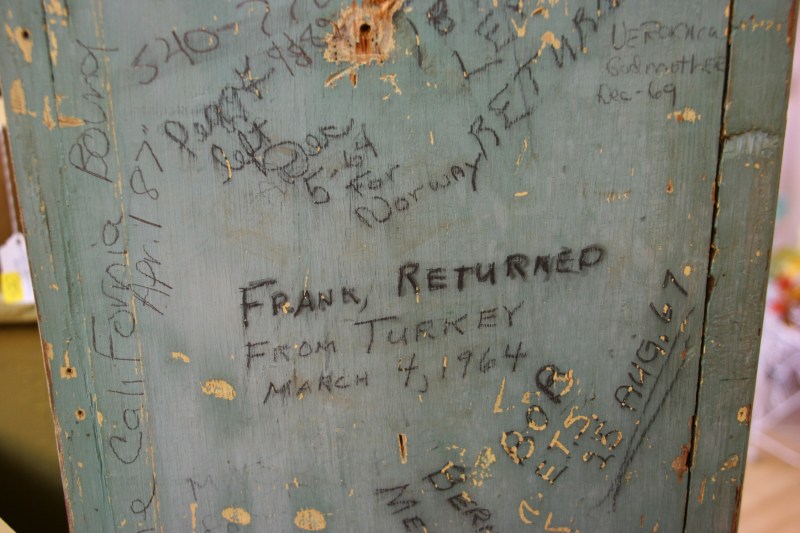 On the side of the cupboard, family members recorded their travels abroad, during the early years to serve in the military. Sarah treasures that detailed history, the reason the cupboard is not for sale.