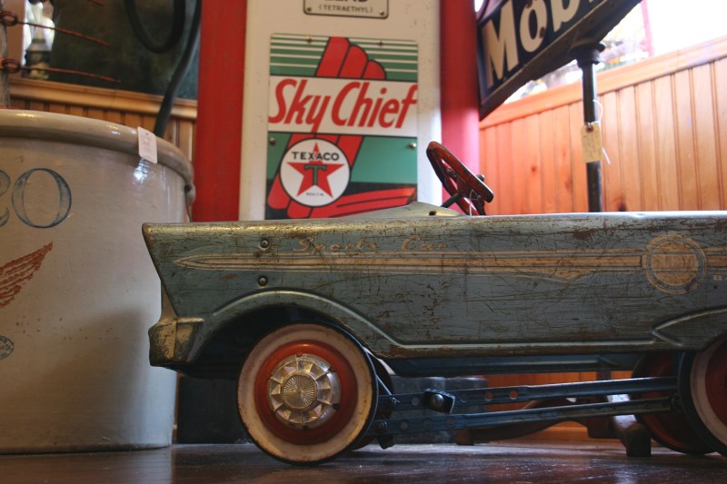 Perfect, a pedal car by the gas pumps.