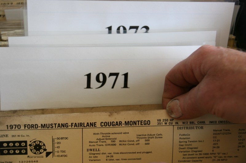 My husband thumbs through auto literature.