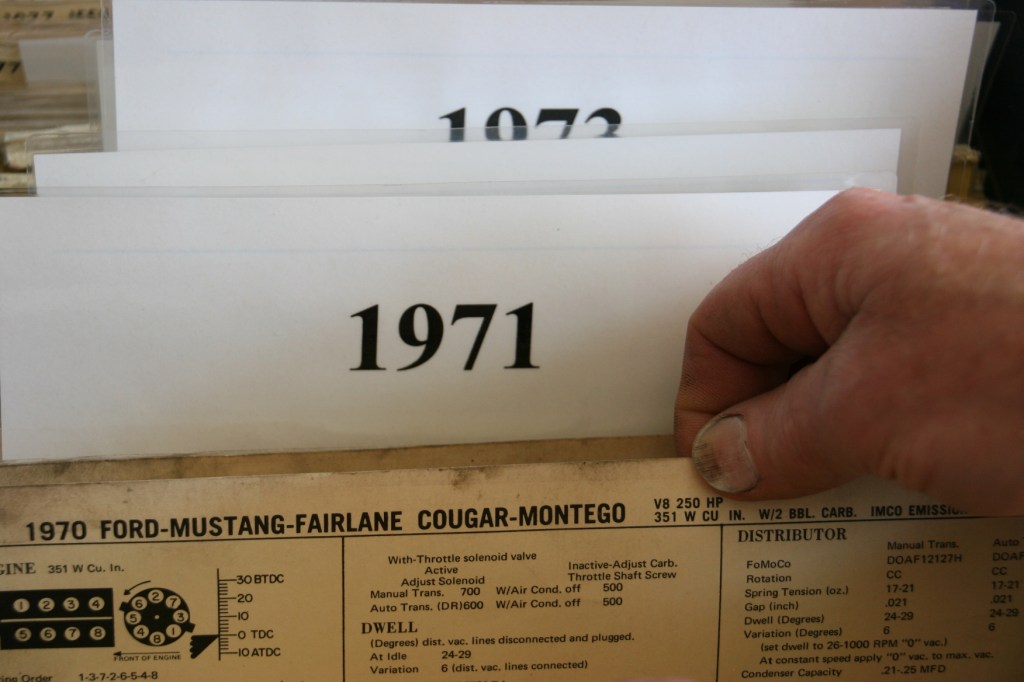 My husband thumbs through auto literature.