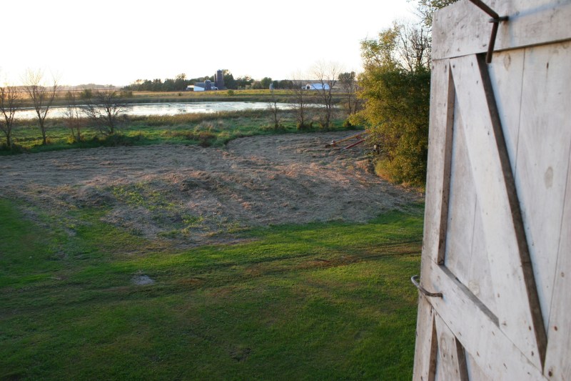 Peering out a hayloft door, I shot this scene of a neighboring farm place.