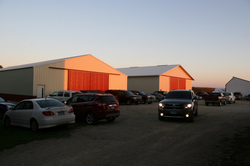 The sun spotlights machine sheds. Vehicles parked in every nook and cranny on the farm.
