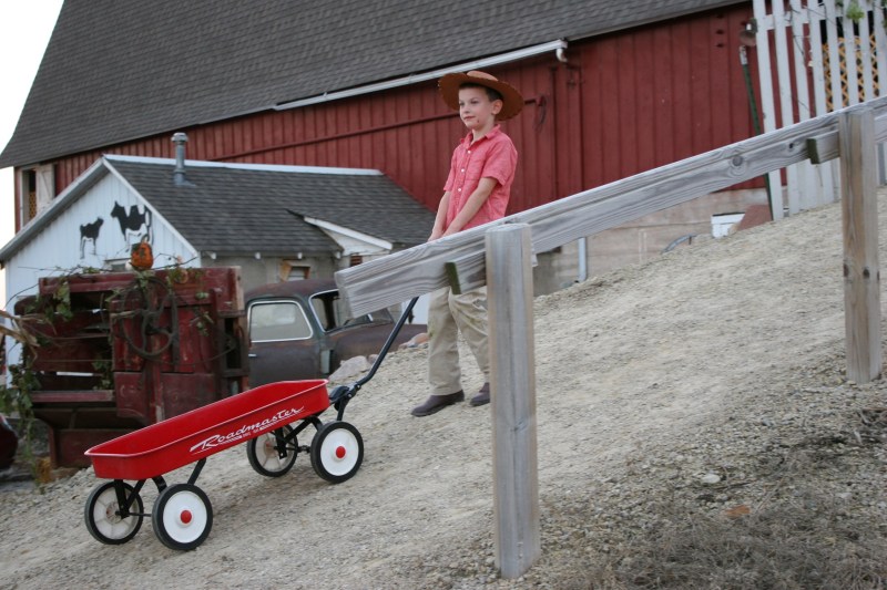 As this boy pulled a wagon up the incline toward the hayloft, I wondered if he would climb aboard for a wild ride down. Instead, he released the wagon. I would have rode down, gripping the handle.