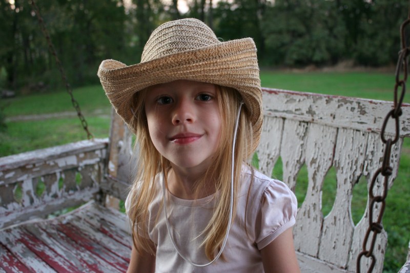 This girl's cowgirl hat reminded me of the straw hats I wore while playing make-believe as a child.