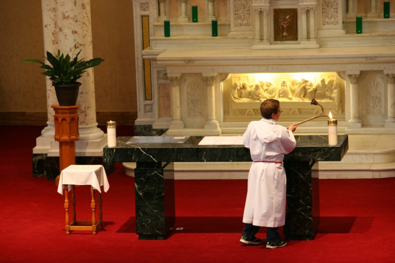 An altar boy prepares for Mass.