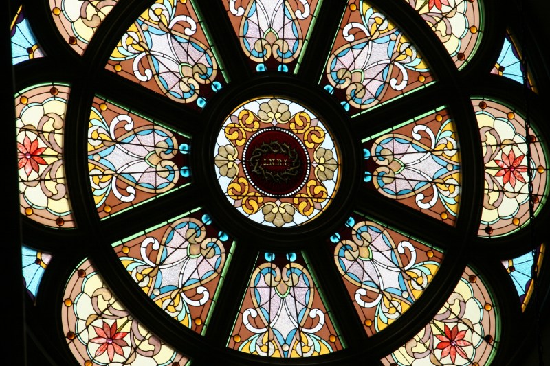 The basilica features stunning stained glass windows.
