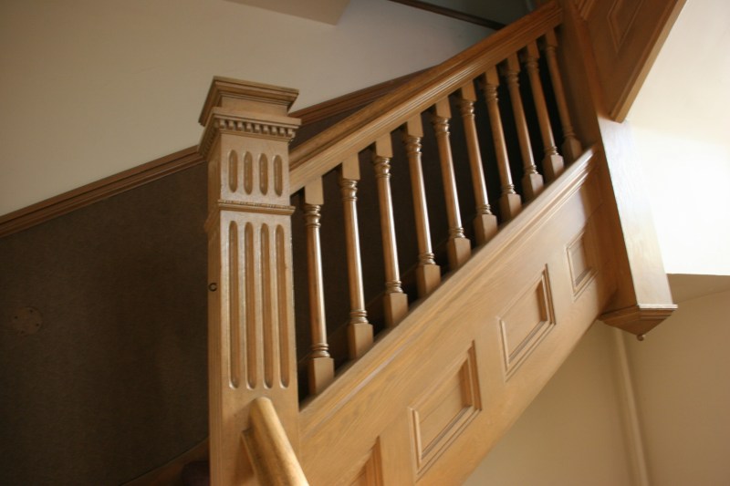 The stairway to the balcony features incredible craftsmanship.