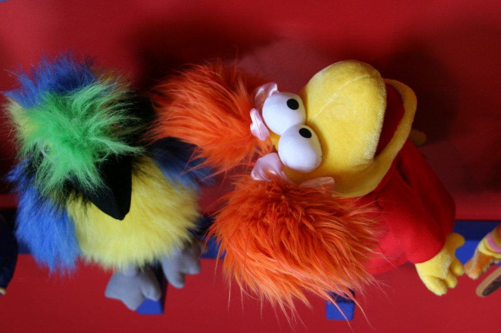 Playful puppets pop color into a section of the multi-room toy store.