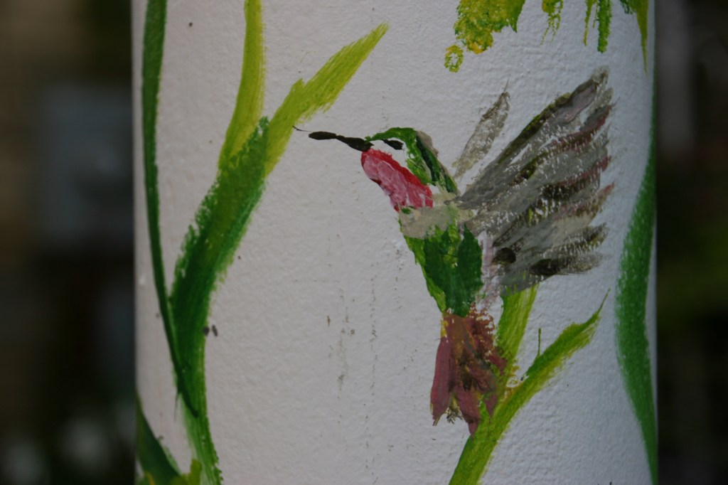 Up close detail on the recently-painted posts. I love this artwork.