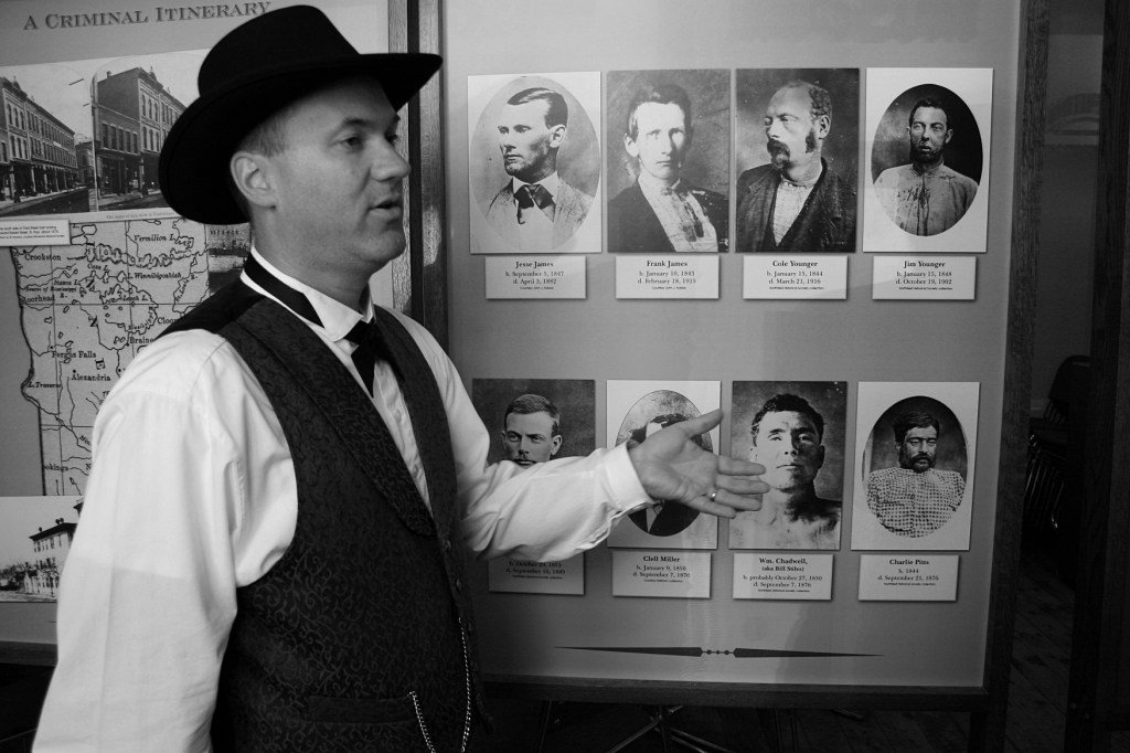 Christian Hakala talks about gang members involved in the Northfield bank raid, pictured to his left: Frank and Jesse James; Cole, Bob and Jim Younger; Clell Miller; William Chadwell; and Charlie Pitts.