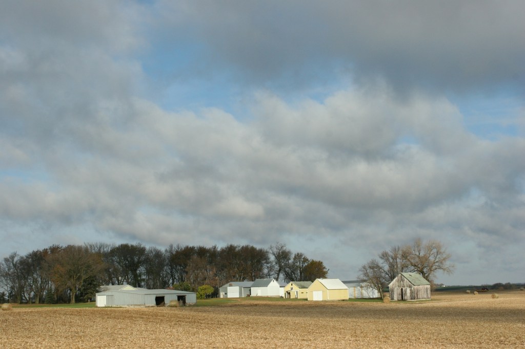 Clouds break apart over a farm along U.S. Highway 14 in southwestern Minnesota.