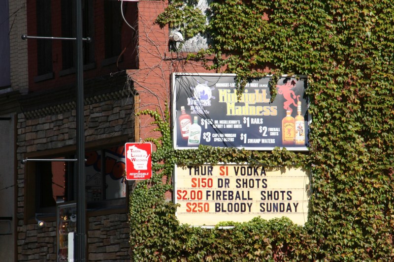 Advertised drink specials alongside a sign that