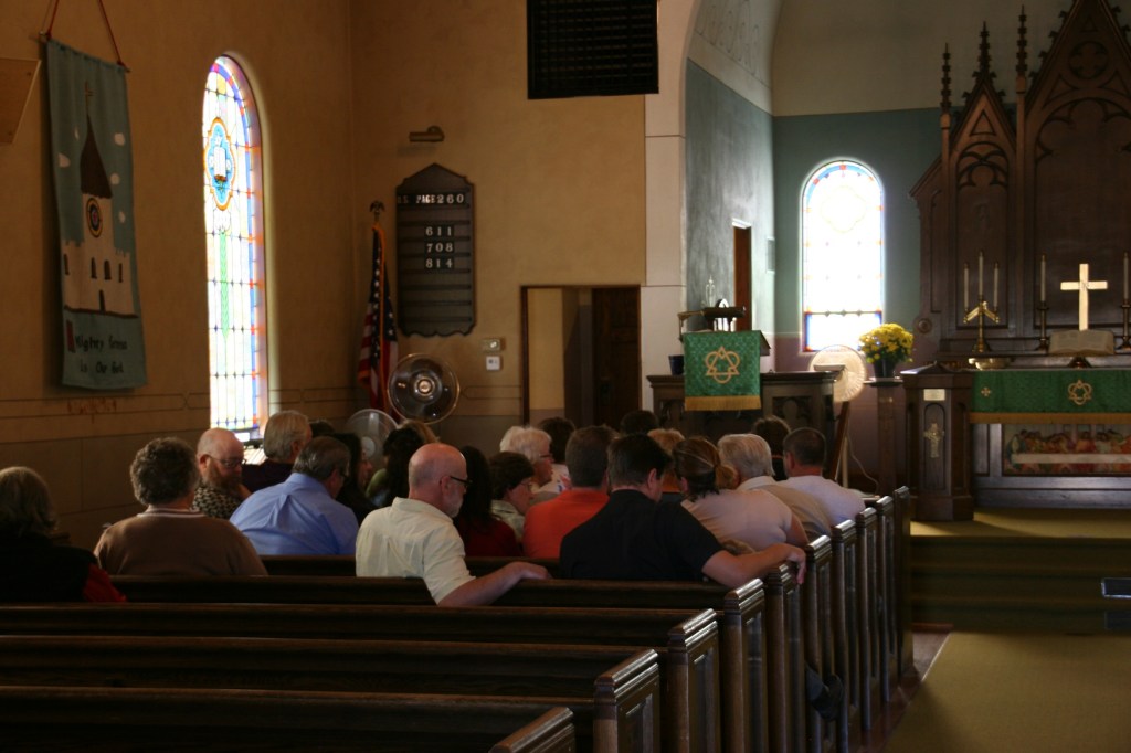 Diners file into the sanctuary through a side door and wait in pews until dining space opens in the basement.