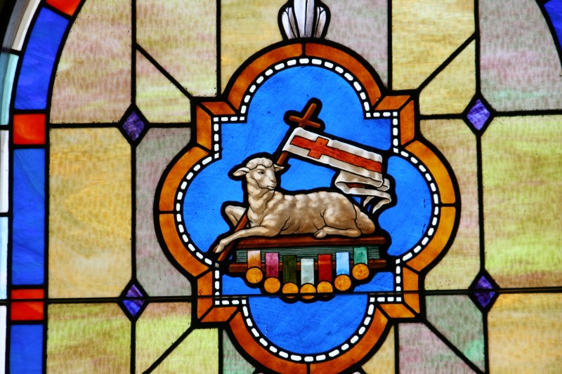 Stunning stained glass windows line the sides of the sanctuary.