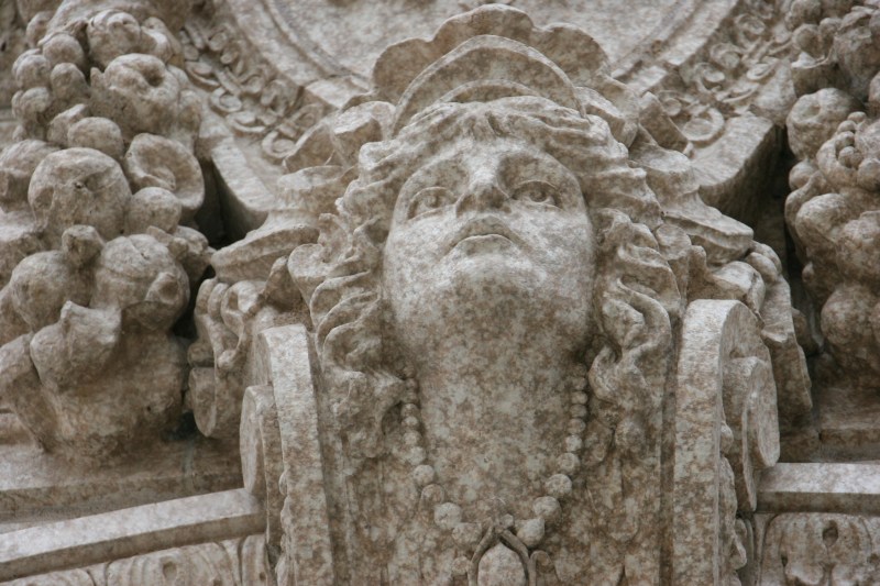 Sculpted lady above the bank building entry.