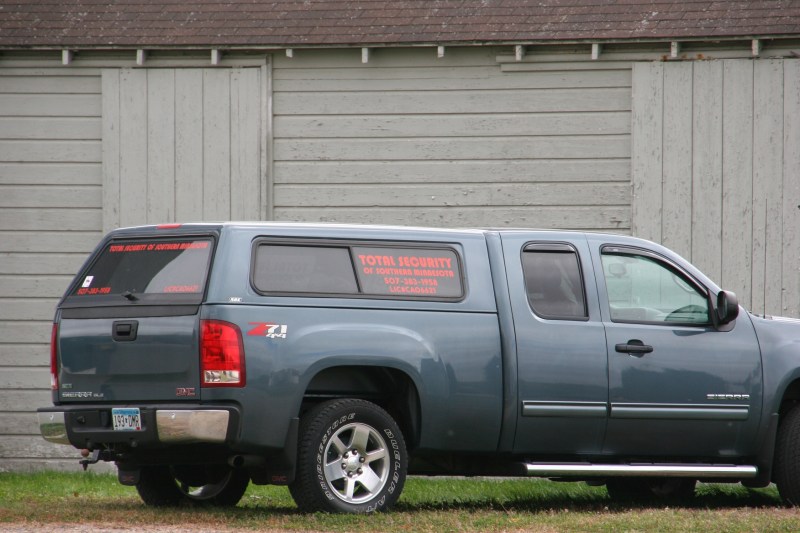 A Total Security truck parked next to the old grain elevator.