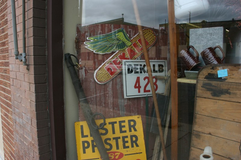 Agricultural merchandise is showcased in a downtown antique store window.