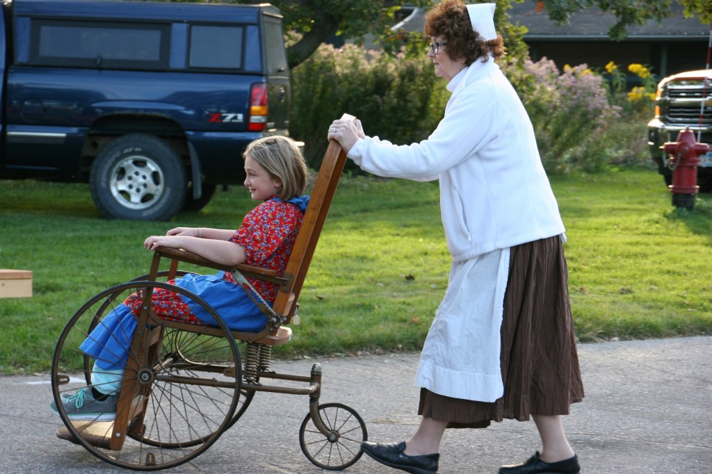 I expect this young girl will remember being pushed around in a wheelchair by a Red Cross nurse during this historical reenactment.