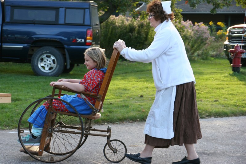 I expect this young girl will remember being pushed around in a wheelchair by a Red Cross nurse during this historical reenactment.