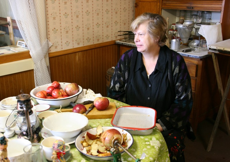 Mrs. Morris takes a break from making applesauce.