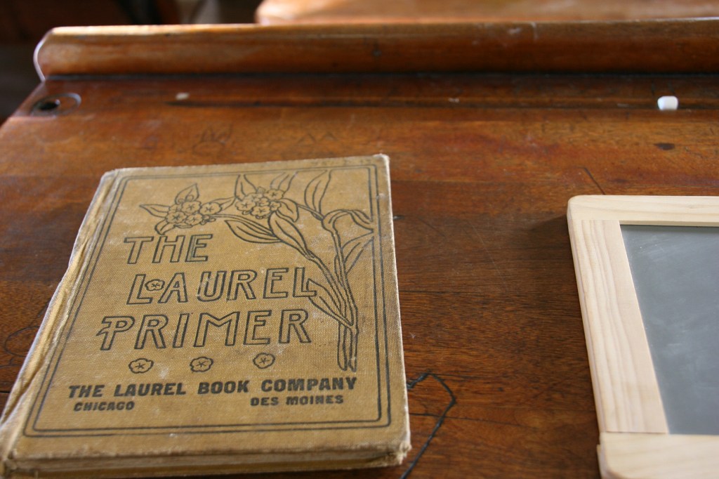 Old books were laid out on school desks.