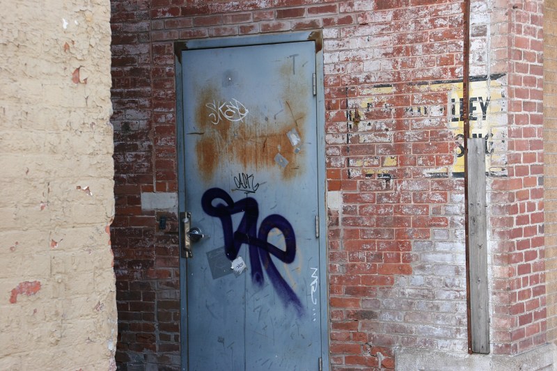 I notice details, even graffiti on a business side door.