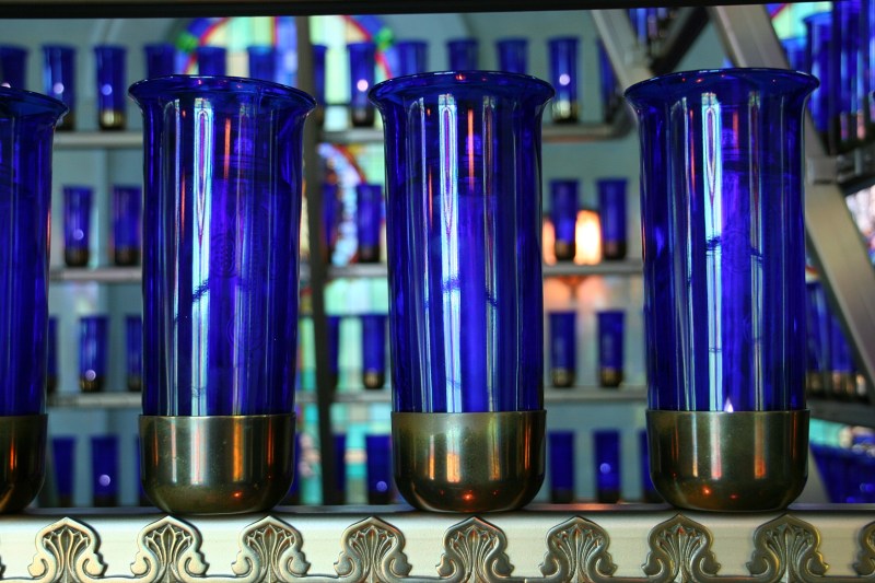 The scent and heat of burning candles prevail in the chapel.