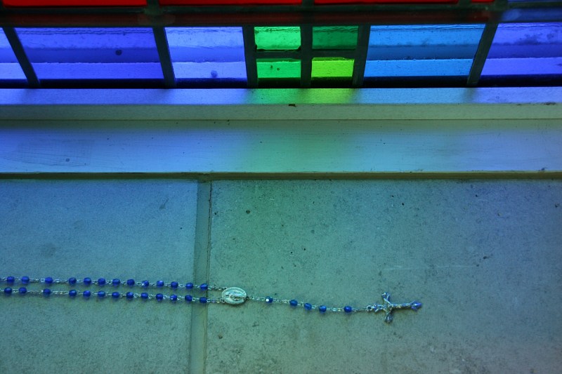 Rosary beads on a chapel window sill.