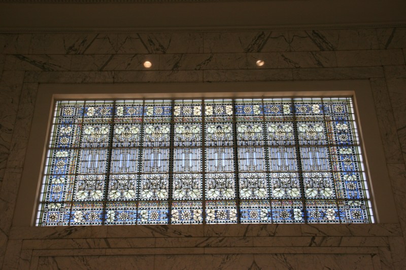 The largest of the Tiffany stained glass windows in the bank looms above the entry. Architect George Maher's Prairie School influences are seen in a design that includes a lotus pattern.