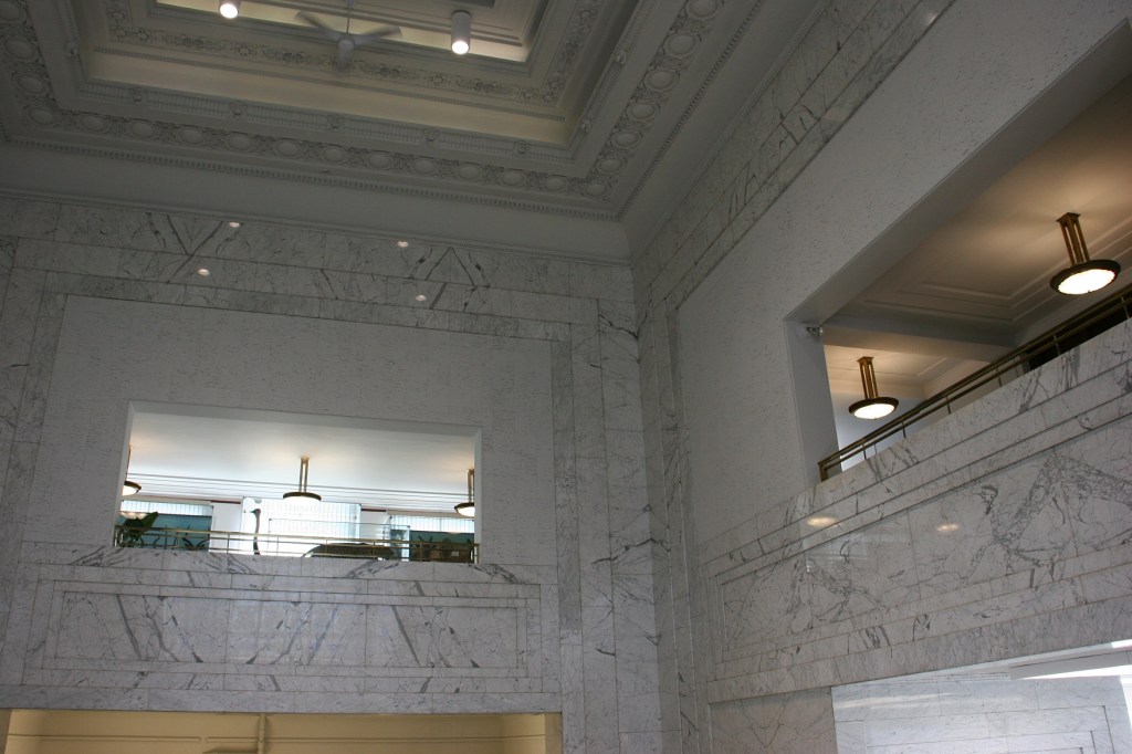 Looking up toward the second floor and the area open to the lower level, the white marble from Italy conveys strength.