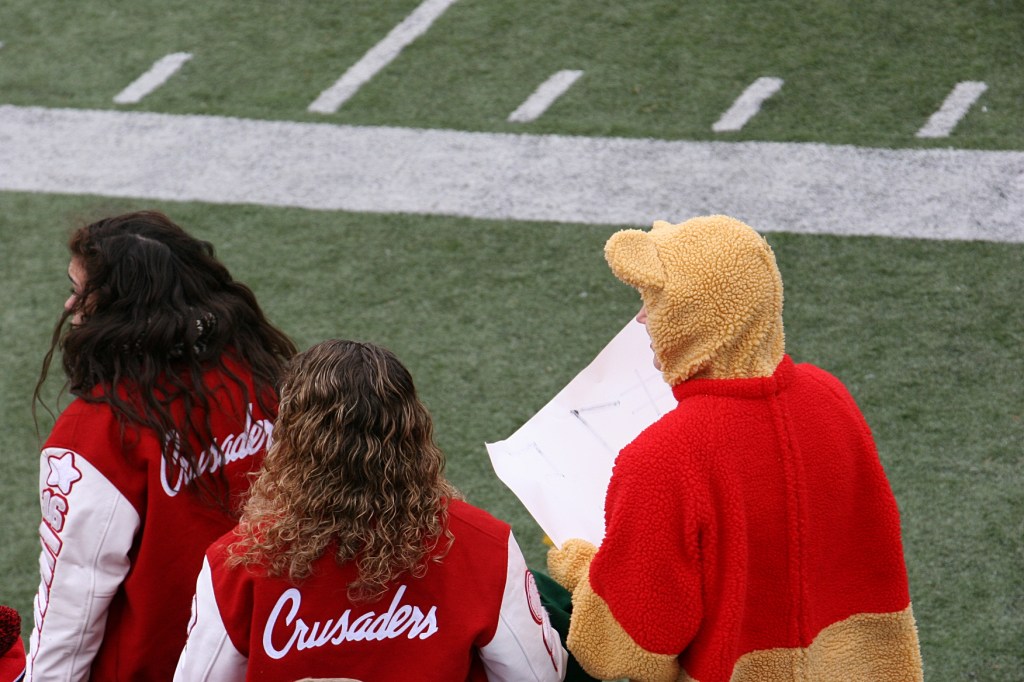 Crusaders fans, including Winnie the Pooh. Some students dressed in Halloween costumes.