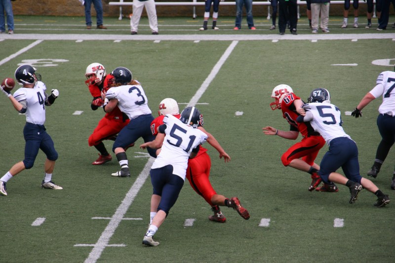 A JCC player prepares to throw the football, left.