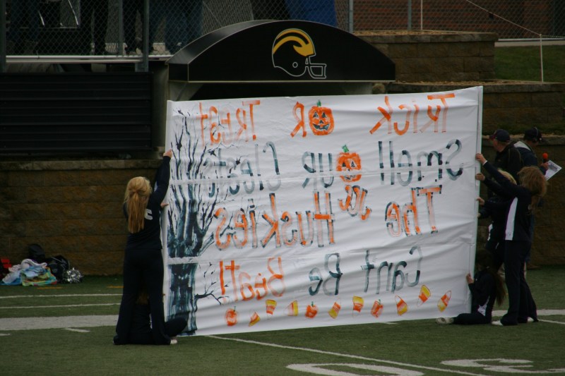 The Halloween themed sign held by the JCC cheerleaders.