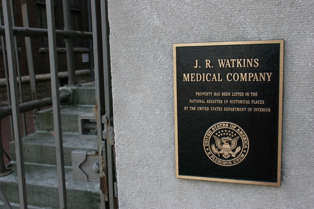 The JR Watkins complex of buildings is on the National Register of Historic Places as noted by this marker.