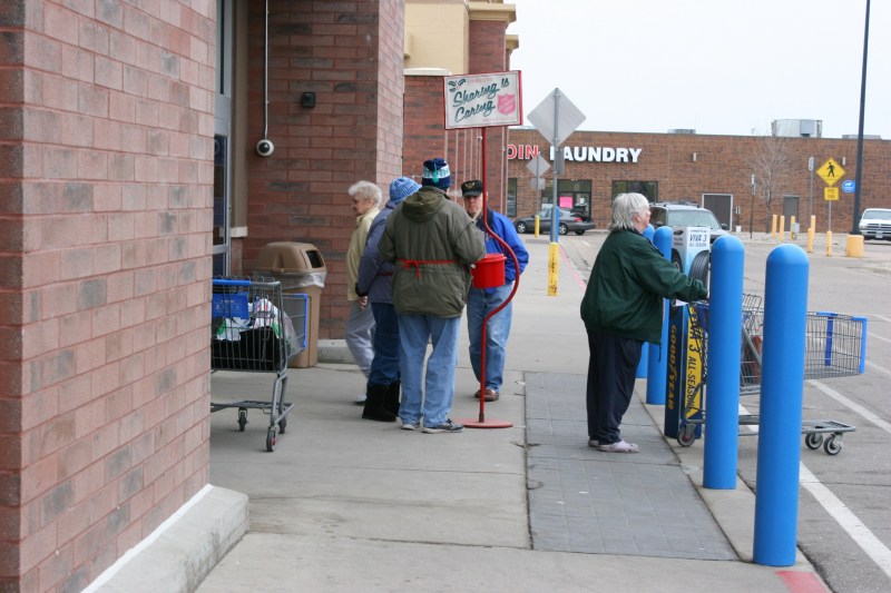Members of Trinity Lutheran Church rang bells at various Faribault locations on Saturday. Here Bud and Bev ring outside of Walmart.