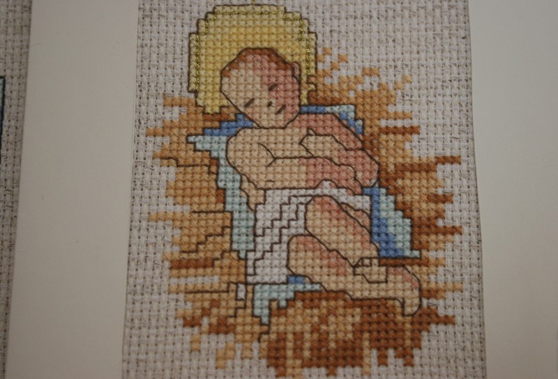 A beautiful cross-stitch of Baby Jesus.