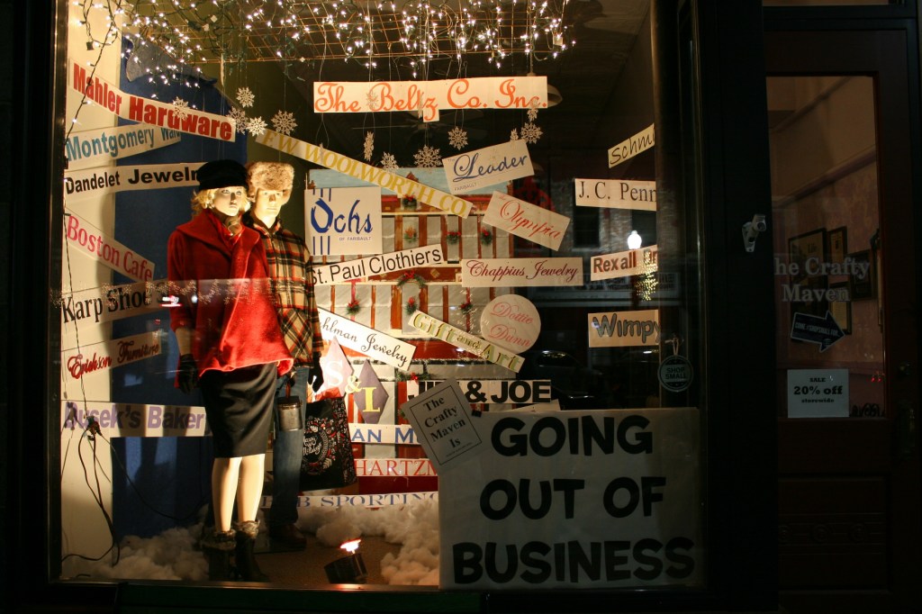 The Crafty Maven created this window display for the vintage themed division of the holiday window decorating contest. The display highlights businesses that were in Faribault when Maven sisters and owners Beth Westerhouse and Dee Bjork were growing up here.
