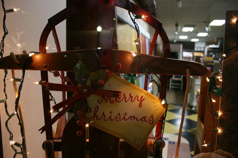 A vintage sled rests in a front window at Vohs Floors,