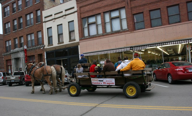 Mike Fuchs guided his horses along Central Avenue on Saturday afternoon for free rides in Santa's Wagon.