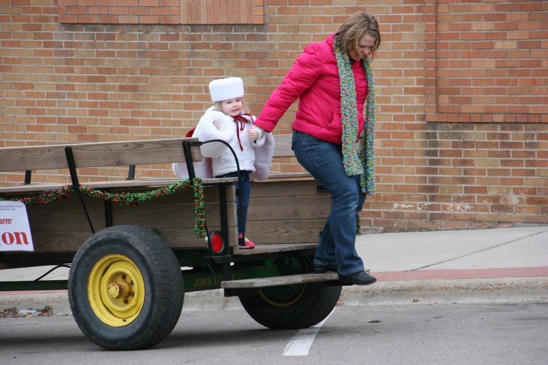 After a ride through downtown Faribault in a horse-drawn wagon, Lyla and her mom exited by the KC Hall.